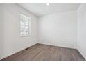 Bright, empty room features neutral walls, light-colored floors, and window bringing in natural light at 4115 Marble Dr, Mead, CO 80504