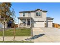 Charming two-story home with a covered front porch and a three-car garage at 4115 Marble Dr, Mead, CO 80504