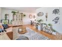 Bright living room featuring hardwood floors, stylish decor, and lots of natural light at 6484 Kendall St, Arvada, CO 80003