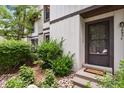 Charming front entrance with a 'Welcome' mat, garden and attractive landscaping around the front door at 3695 S Kittredge St # C, Aurora, CO 80013