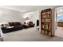 Comfortable living room featuring plush seating, open layout, and a bookshelf with personal items at 3695 S Kittredge St # C, Aurora, CO 80013