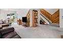 Bright living room showcasing the stairwell, an open concept layout, and a sliding glass door at 3695 S Kittredge St # C, Aurora, CO 80013
