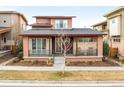 Charming home featuring a cozy front porch with rocking chairs and attractive architectural details at 89 Oneida St, Denver, CO 80230