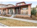 Charming home featuring a cozy front porch with rocking chairs and attractive architectural details at 89 Oneida St, Denver, CO 80230