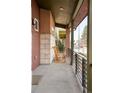 Inviting front porch featuring stone accents, rocking chairs, and views of the neighborhood at 89 Oneida St, Denver, CO 80230