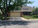 Traditional two-story home featuring an attached two-car garage and well-maintained landscaping at 11600 E Adriatic Pl, Aurora, CO 80014