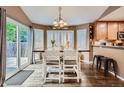 Charming dining area featuring a large table, stylish chairs, and sliding doors leading to outdoor space at 16200 Hedgeway Dr, Parker, CO 80134