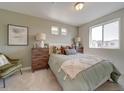 A beautifully decorated bedroom with neutral tones, ample natural light, and a comfortable aesthetic at 13059 E 103Rd Pl, Commerce City, CO 80022