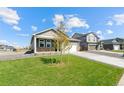 Well-maintained home with a spacious front yard featuring a young tree and lush green grass at 4692 Hatcher Dr, Brighton, CO 80601