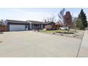 Wide driveway leading up to a well-maintained single Gathering home with charming curb appeal and an attached two car garage at 4833 S Elati St, Englewood, CO 80110