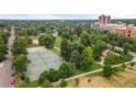 An aerial view of lush green community park, tennis courts, and play areas at 1182 Clermont St # 201, Denver, CO 80220