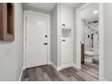 Hallway leads to a sleek bathroom featuring marble tile and modern fixtures at 1182 Clermont St # 201, Denver, CO 80220