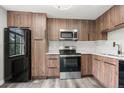 Kitchen featuring stainless steel appliances, wood cabinets, and a sleek design at 1182 Clermont St # 201, Denver, CO 80220