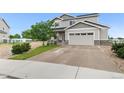 Charming two-story home with neutral siding, stone accents, an attached two car garage, and well manicured yard at 601 Morrison Dr, Frederick, CO 80530