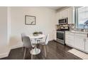 Bright kitchen and dining area with stainless appliances and modern tile backsplash at 2507 Moline St, Aurora, CO 80010