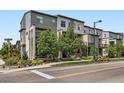 Modern townhome complex with mature landscaping, sidewalks, and street parking at 2507 Moline St, Aurora, CO 80010