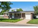 Brick home with attached one car garage, small front porch and well maintained lawn at 11917 Lavinia Way, Northglenn, CO 80233