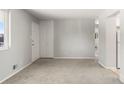 Spacious living area with carpet, neutral paint, closet, and access to other rooms at 11917 Lavinia Way, Northglenn, CO 80233