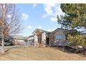 Charming single-story home featuring a two-car garage, stone accents, and well-maintained landscaping at 17 Canon Dr, Greenwood Village, CO 80111