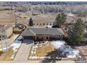 Aerial view of a brick home with a spacious yard, mature trees, and a long driveway at 4192 S Vrain St, Denver, CO 80236