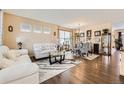 Bright living room with elegant decor and hardwood floors flowing into the dining area at 13626 Garfield St # A, Thornton, CO 80602