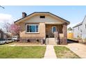 Charming brick home with a well-maintained front yard and inviting porch at 3139 Chase St, Wheat Ridge, CO 80214