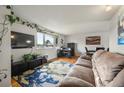 Comfortable living area with a large window, modern furniture, hardwood floors, and ample natural light at 2009 S Zephyr Ct, Lakewood, CO 80227