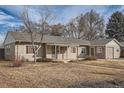 Charming ranch home with a spacious front yard and attached garage at 4981 E Cornell Ave, Denver, CO 80222