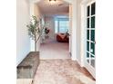 Welcoming foyer with tile flooring, a decorative bench, and an arched doorway leading to the living room at 26032 E Geddes Cir, Aurora, CO 80016
