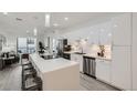 Open concept kitchen with stainless steel appliances, sleek cabinets, and an island with stool seating at 3500 S Corona St # 407, Englewood, CO 80113