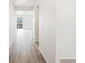 Bright hallway with hardwood floors leading to an airy living space, perfect for welcoming guests into your new home at 1937 S Coolidge Way, Aurora, CO 80018
