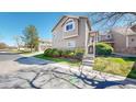Beautiful townhouse with well maintained landscaping and a sidewalk street view at 7700 W Grant Ranch Blvd # 4A, Littleton, CO 80123