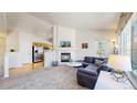 Spacious living room featuring a fireplace, TV, and open layout to kitchen at 7700 W Grant Ranch Blvd # 4A, Littleton, CO 80123
