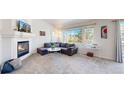Bright living room with a cozy fireplace, large windows, and stylish decor at 7700 W Grant Ranch Blvd # 4A, Littleton, CO 80123