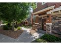 Charming townhouse complex with well-maintained landscaping and inviting walkways at 7090 Simms St # 202, Arvada, CO 80004