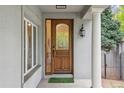 Close-up of elegant wooden front door with stained glass window and side-light at 600 Vine St, Denver, CO 80206