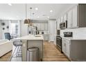 Modern kitchen with stainless steel appliances and an island at 9914 Truckee St, Commerce City, CO 80022