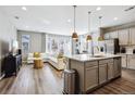 Open floor plan with modern kitchen, island, and spacious living room at 9914 Truckee St, Commerce City, CO 80022