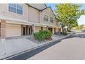 View of townhome exteriors with attached garages and landscaping along the street at 2154 Concord Ln, Superior, CO 80027