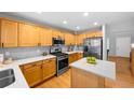 Bright kitchen features stainless appliances, light countertops, herringbone backsplash, and ample wood cabinetry at 3529 Huron Peak Ave, Superior, CO 80027