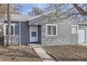 A charming gray house with a walkway and mature trees at 1716 Akron St, Aurora, CO 80010