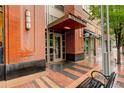 Condo entrance with brick facade, sleek lighting, and distinctive address signage at 191 Clayton Ln # 402, Denver, CO 80206