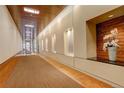 Modern condo hallway featuring recessed lighting, wood accents, and decorative art display at 191 Clayton Ln # 402, Denver, CO 80206