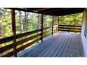 Spacious wooden deck overlooking a lush, wooded area, perfect for outdoor relaxation at 7105 Flagstaff Rd, Boulder, CO 80302