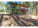 Charming exterior elevation of a two story home with a deck nestled amongst the trees at 7105 Flagstaff Rd, Boulder, CO 80302
