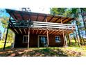 Charming home exterior featuring a spacious two-story deck with wooden support beams and a cozy cabin feel at 7105 Flagstaff Rd, Boulder, CO 80302
