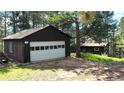 View of detached garage, including white door and space for vehicles and/or storage at 7105 Flagstaff Rd, Boulder, CO 80302
