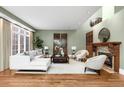 Comfortable living room with decorative fireplace, hardwood floors, and many windows at 465 Monroe St, Denver, CO 80206