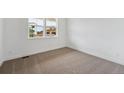 Bright bedroom featuring plush carpeting, neutral walls and a window with a view of the outdoors at 7036 E 126Th Pl, Thornton, CO 80602