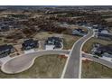 Scenic aerial view of a modern home in a lovely community nestled among rolling hills and mature trees at 3226 Wingspan Pt, Castle Rock, CO 80108